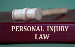 Gavel resting on a legal book labeled “Personal Injury Law”—symbolizing legal action for uninsured motorist accidents in Illinois.